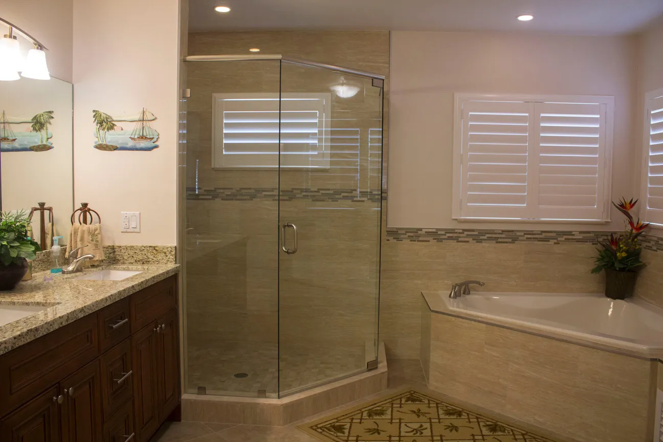 Primary bath — granite double vanity, glass shower, soaking tub