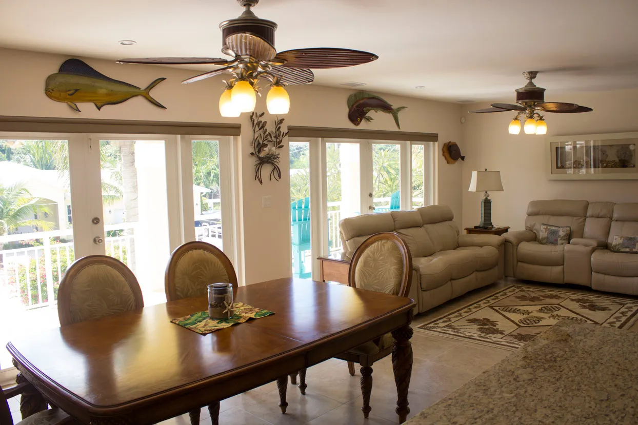 Open living and dining area — French doors to the wraparound balcony