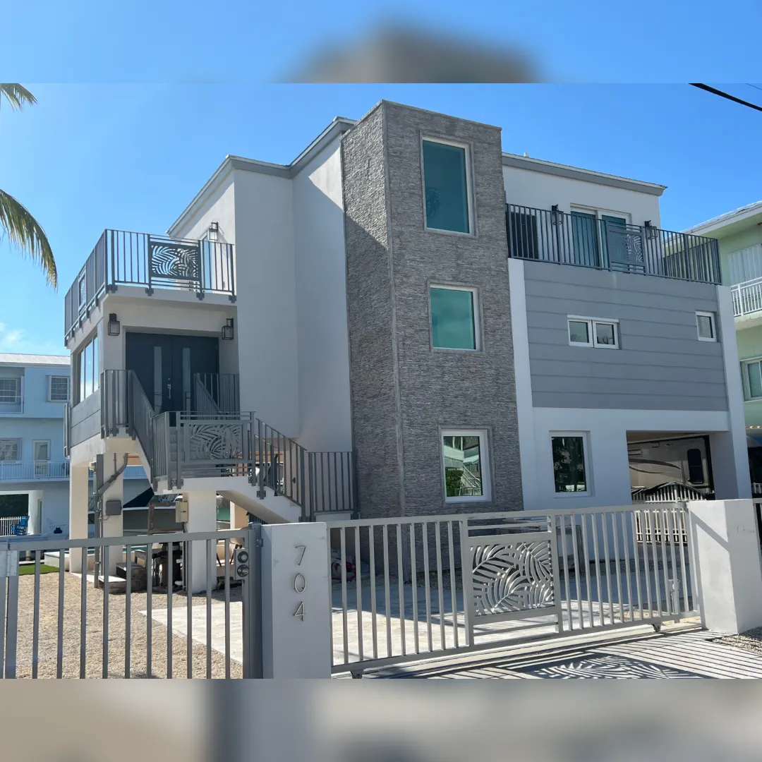 Front elevation — 3-story modern remodel at 704 Grouper Lane